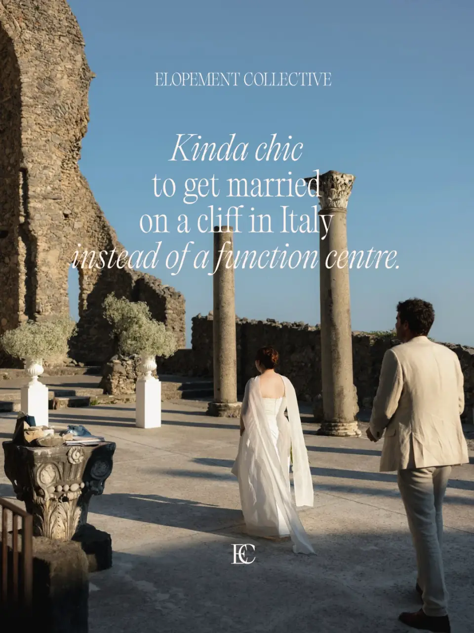 A couple walking through Roman ruins under a clear blue sky. Kinda chic to get married on a cliff in Italy instead of a function centre.